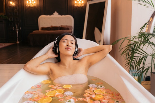 Woman listening to music while taking a bath